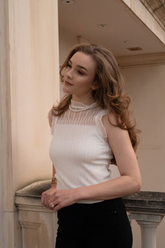 a lady wears a white tank top with black skinny jeans